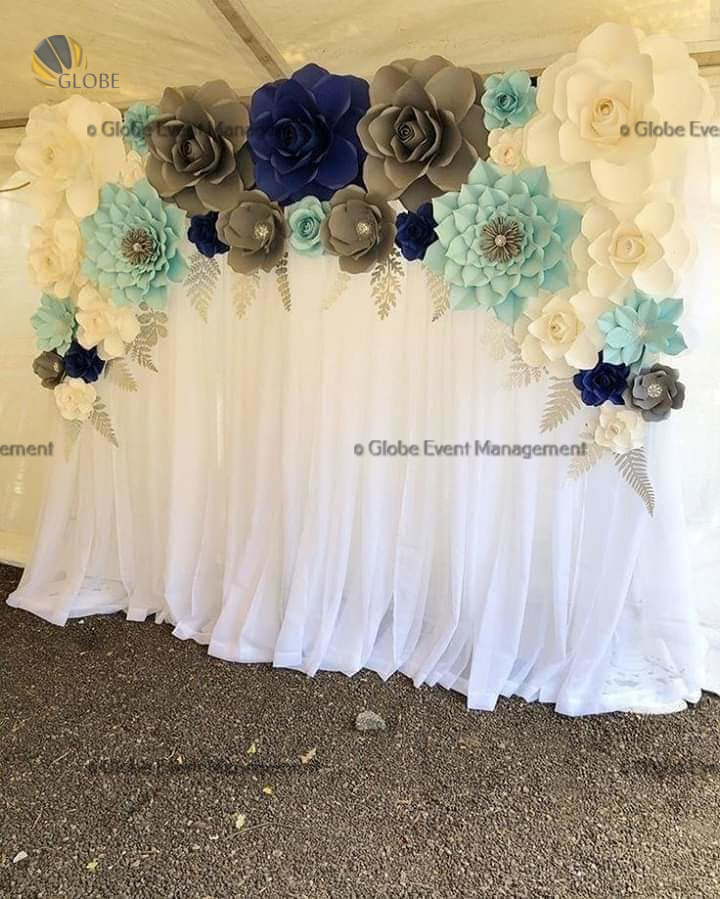 Professionally organized corporate seminar with stage and seating arrangements. Stylish product launch event setup with lights and branded backdrops. Corporate gala dinner with elegant table decor and ambient lighting. Annual day event with large LED screens and stunning stage setup. Beautifully arranged outdoor seating for a private party event. Event management team setting up a large stage for a gala night. Stunning decor featuring floral arches and chandeliers for an event. Table setup with elegant glassware and centerpiece for a formal event. Stunning flower decoration for a grand wedding entrance. Outdoor event lighting with string lights and lanterns creating a magical ambiance. Creative flower arrangement for a corporate event stage. Romantic candlelight decor with floral centerpieces for a party. Wedding Planners in Bangalore