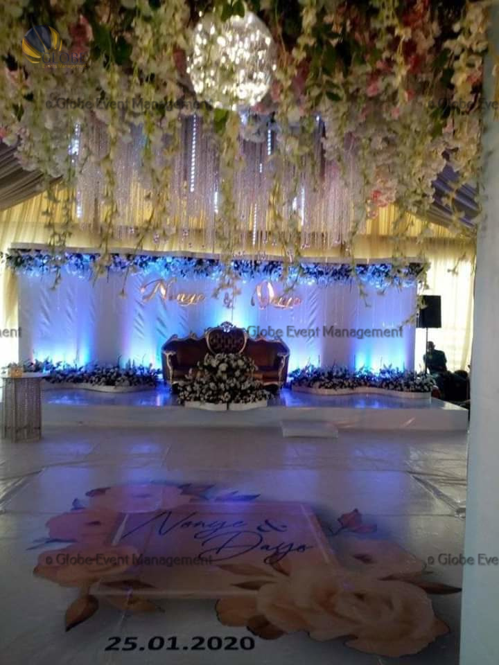 Professionally organized corporate seminar with stage and seating arrangements. Stylish product launch event setup with lights and branded backdrops. Corporate gala dinner with elegant table decor and ambient lighting. Annual day event with large LED screens and stunning stage setup. Beautifully arranged outdoor seating for a private party event. Event management team setting up a large stage for a gala night. Stunning decor featuring floral arches and chandeliers for an event. Table setup with elegant glassware and centerpiece for a formal event. Stunning flower decoration for a grand wedding entrance. Outdoor event lighting with string lights and lanterns creating a magical ambiance. Creative flower arrangement for a corporate event stage. Romantic candlelight decor with floral centerpieces for a party.